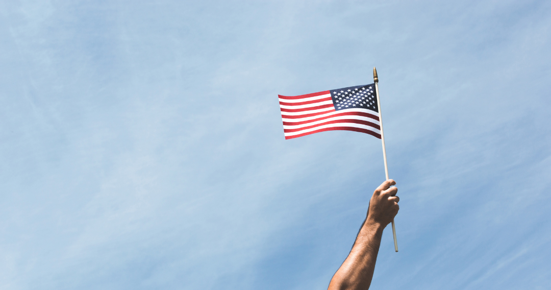 American Flag being held high