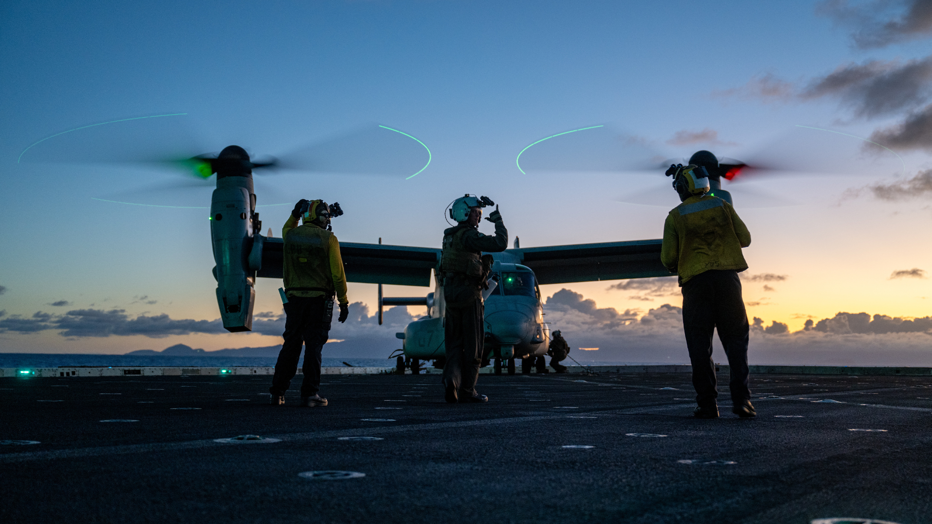 Marine Corps Ground Grew preparing an Osprey for takeoff