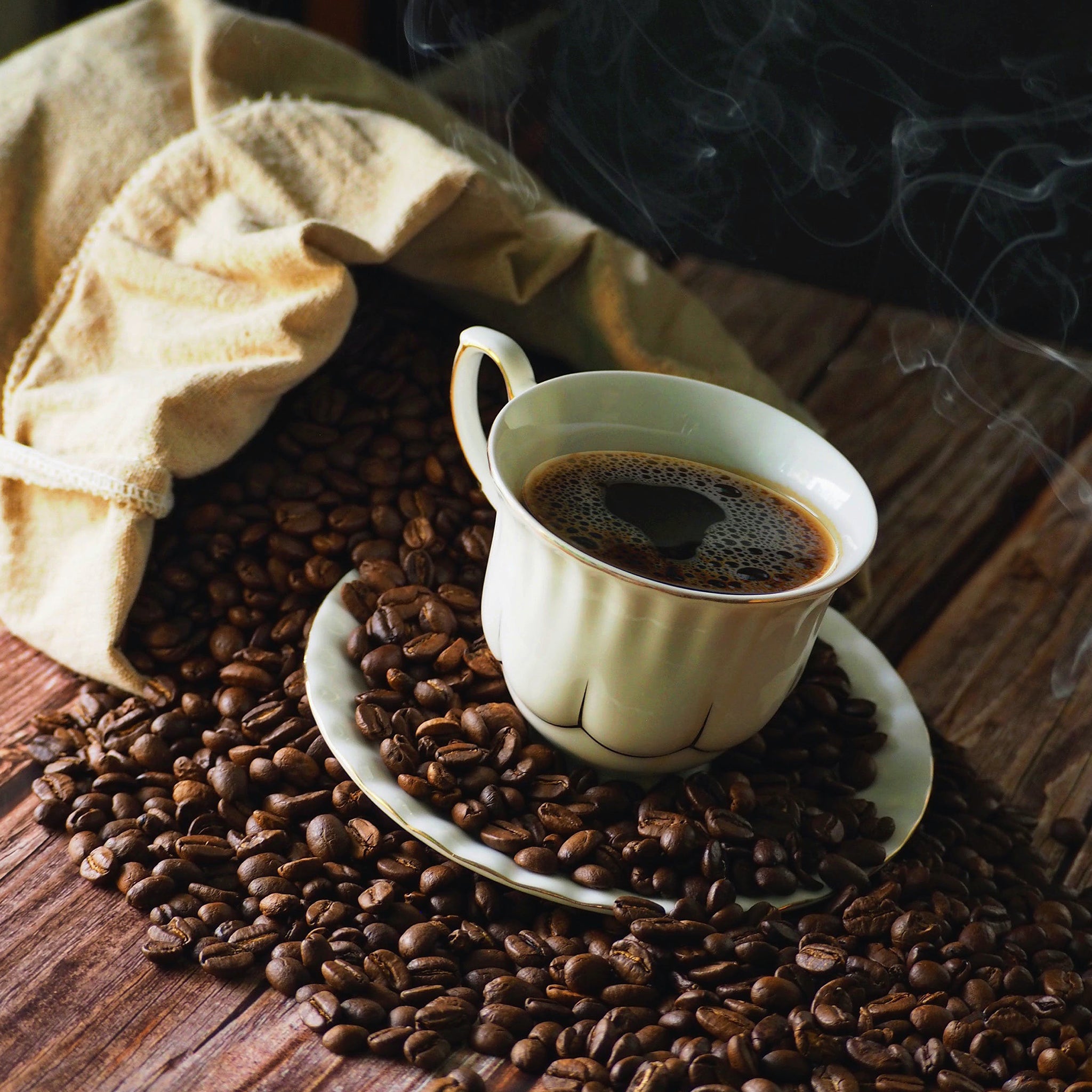 Cortado Vs Macchiato - coffee beans on a green background and the aerial resupply coffee logo