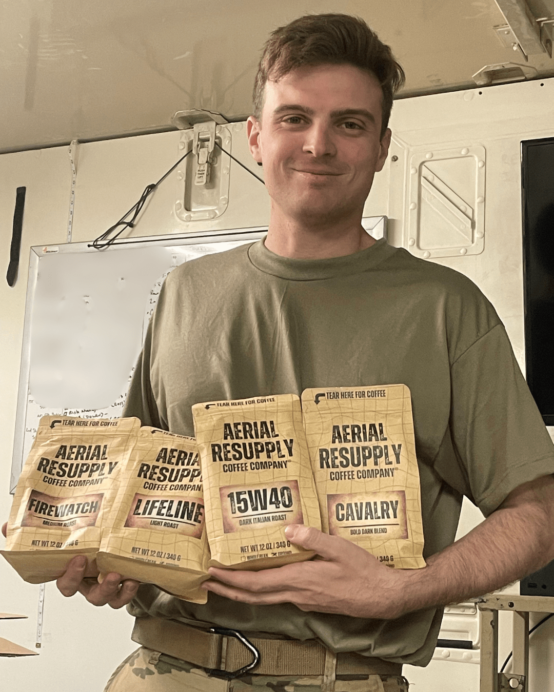 A Soldier holding bags of Aerial Resupply Coffee