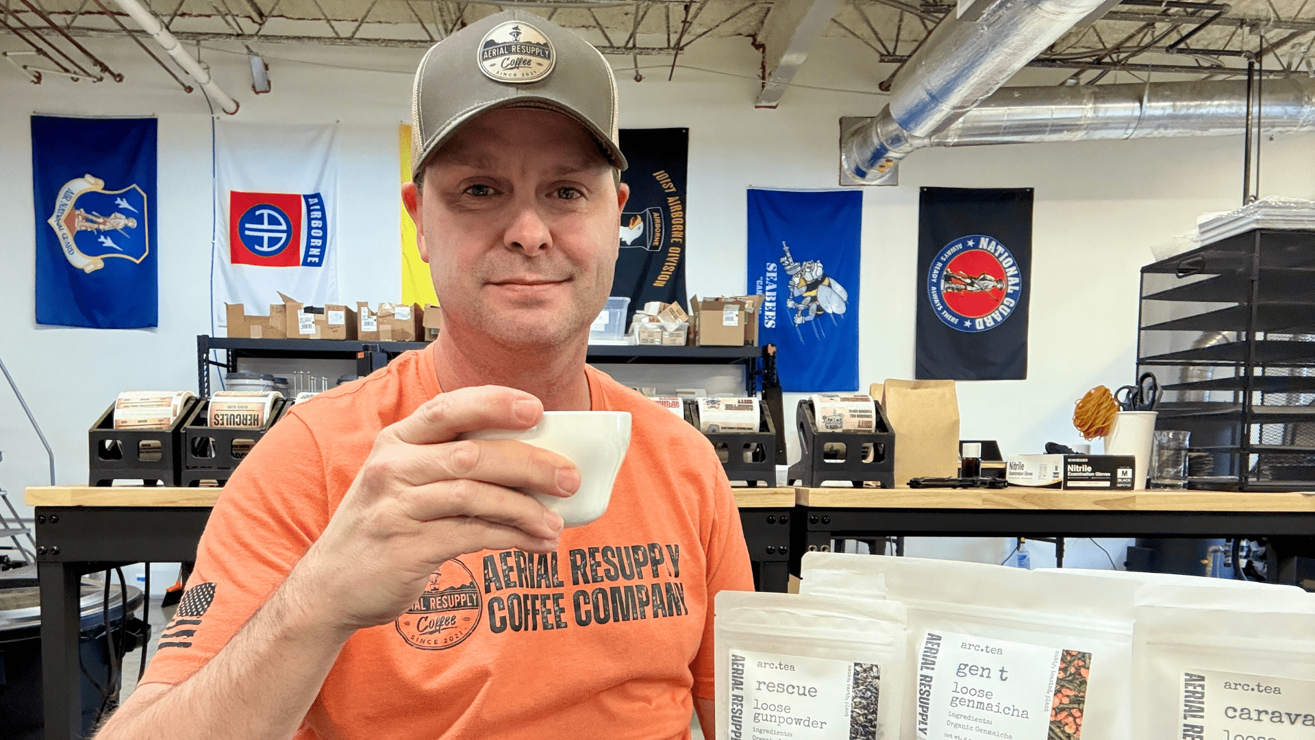 a man sitting at a table wtih a cup of coffee