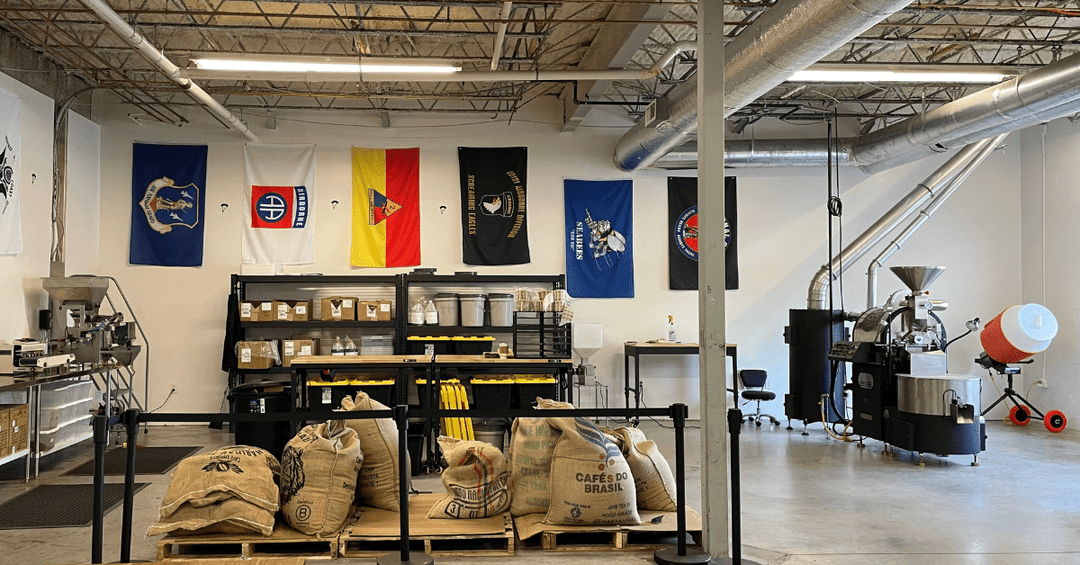 Coffee bags and a coffee roaster in a warehouse