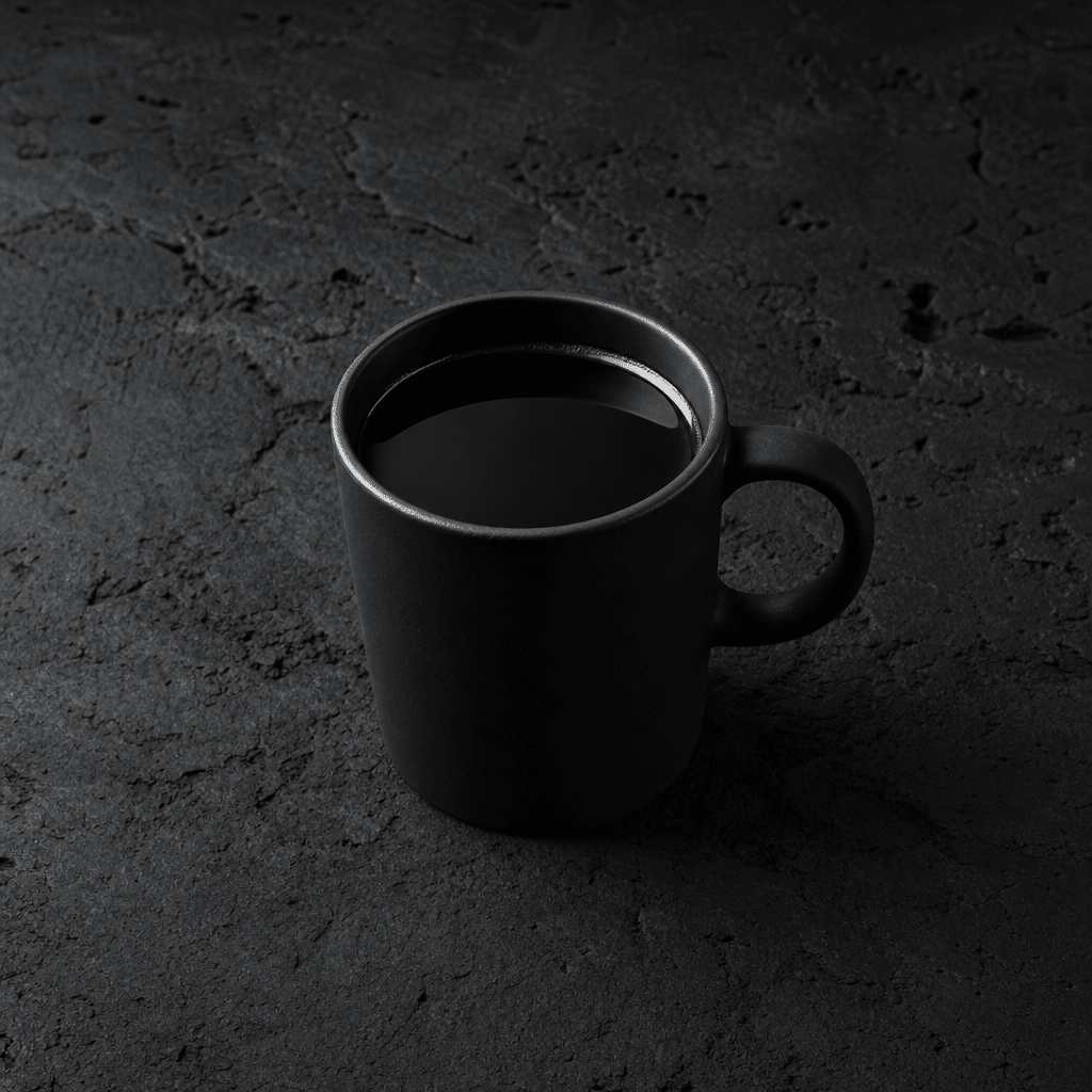 Minimalist black coffee mug on dark stone — black coffee and weight loss
