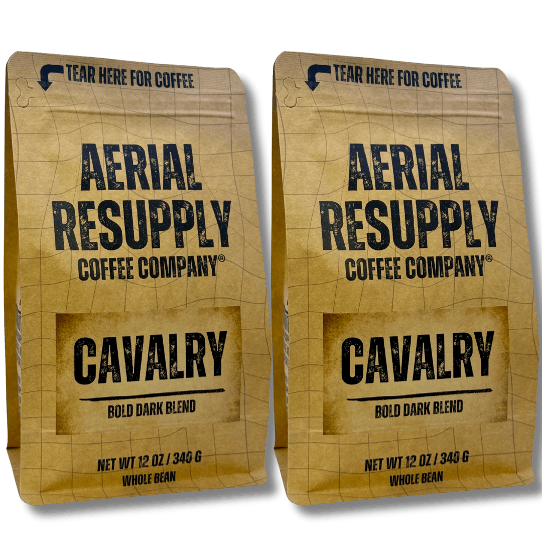 Two packages of Aerial Resupply Coffee Company Cavalry Bold Dark Blend coffee on a white background.