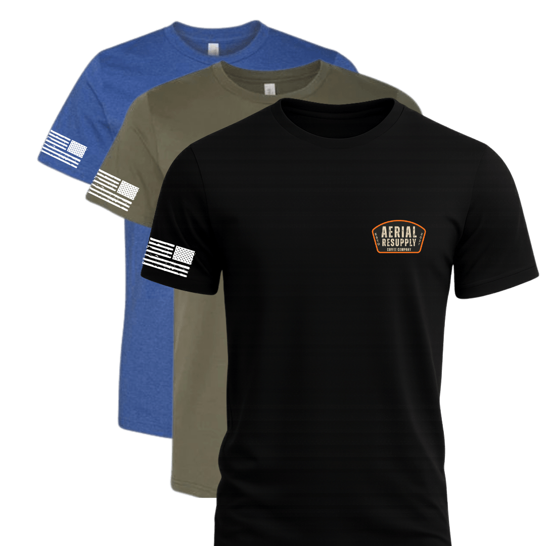Three t-shirts in blue, green, and black with different designs on a white background