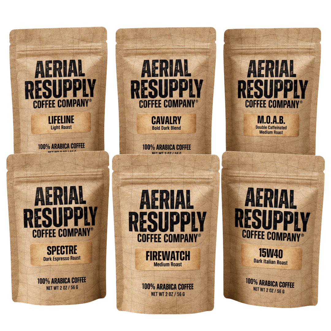 Six stand-up coffee pouches from Aerial Resupply Coffee Company arranged in two rows on a white background. The kraft paper bags show different roast options: Lifeline, Cavalry, M.