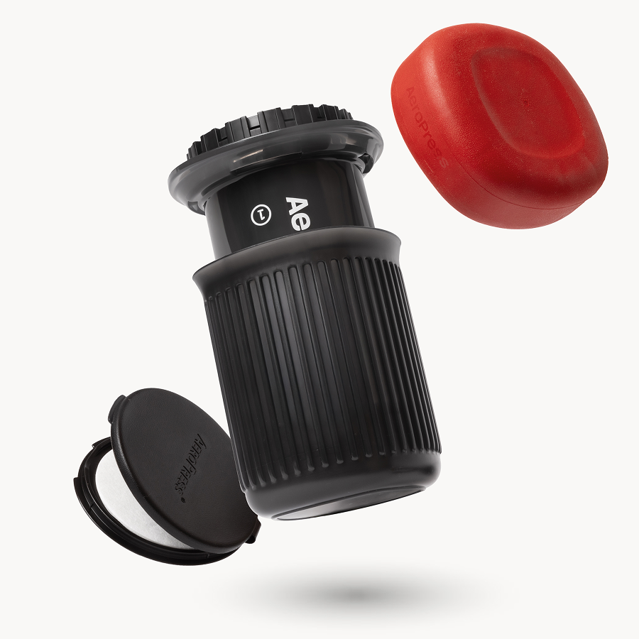 AeroPress Go packed down into its own mug with the red silicone travel lid