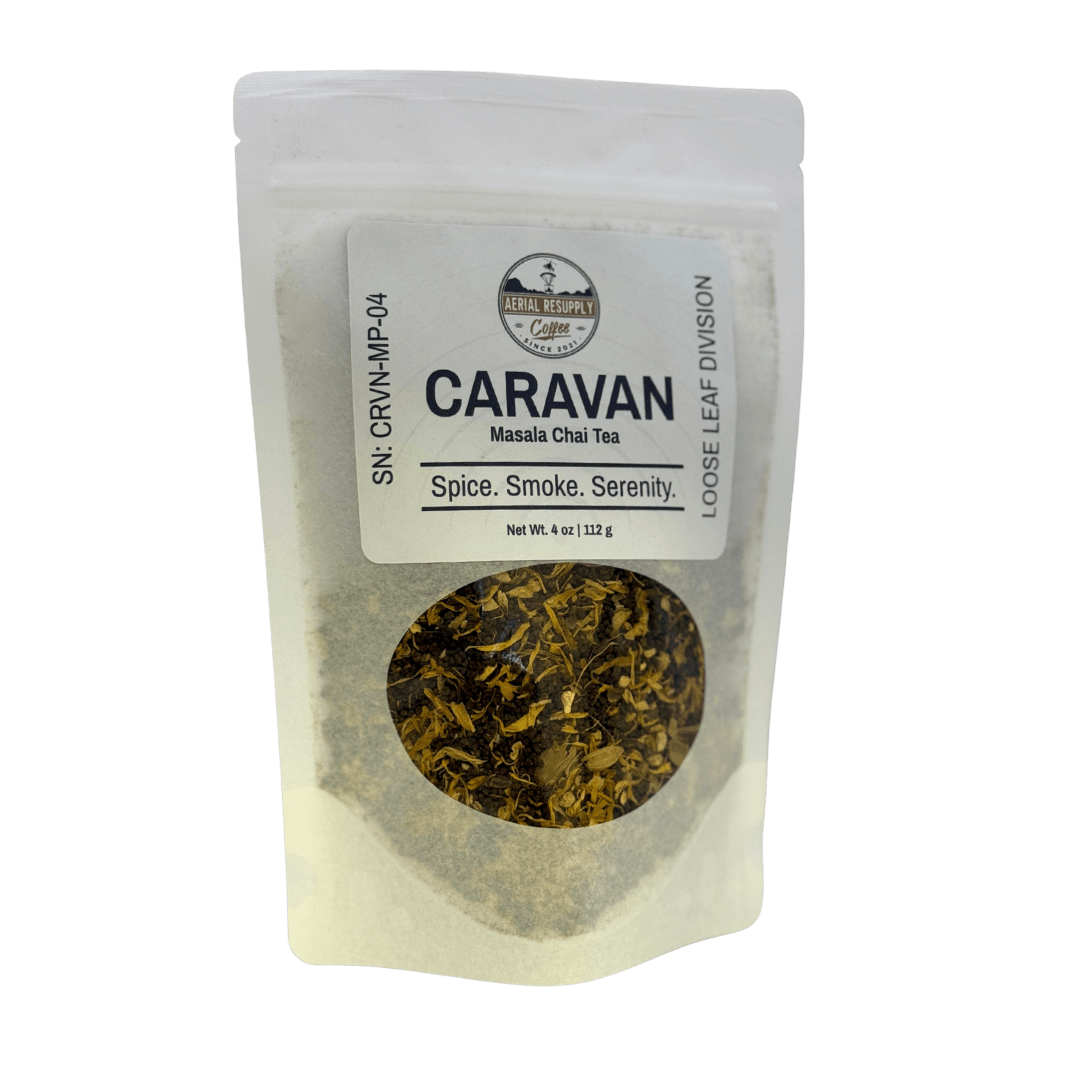 Tea package labeled 'Caravan' with visible tea leaves on a white background