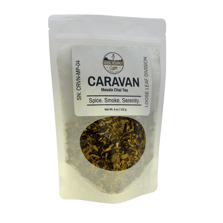 Tea package labeled 'Caravan' with visible tea leaves on a white background