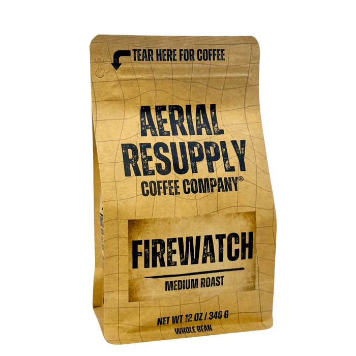 Packaging for Aerial Resupply Coffee Company's Firewatch medium roast coffee, featuring a tan and brown design with text and tear here for coffee instructions.