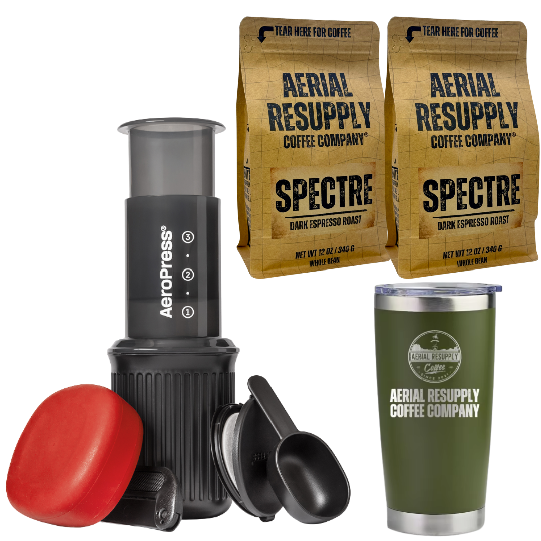 two bags of spectre with an aeropress go travel kit and a laser etched tumbler