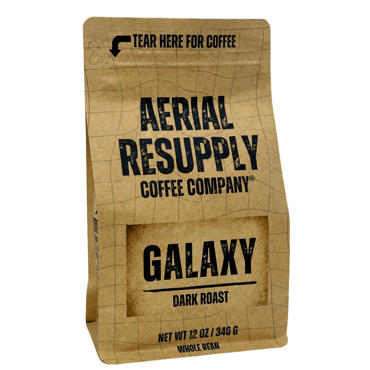 A 12 oz bag of Galaxy Dark Roast coffee from Aerial Resupply Coffee Company, featuring a kraft paper bag design with black text and a grid pattern, isolated on a white background.