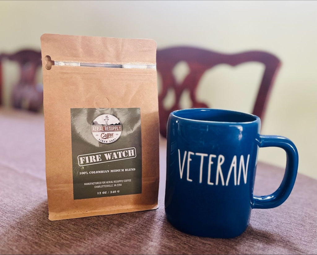 Fire Watch Coffee from Aerial Resupply Coffee sitting on a table next to a coffee mug that says Veteran