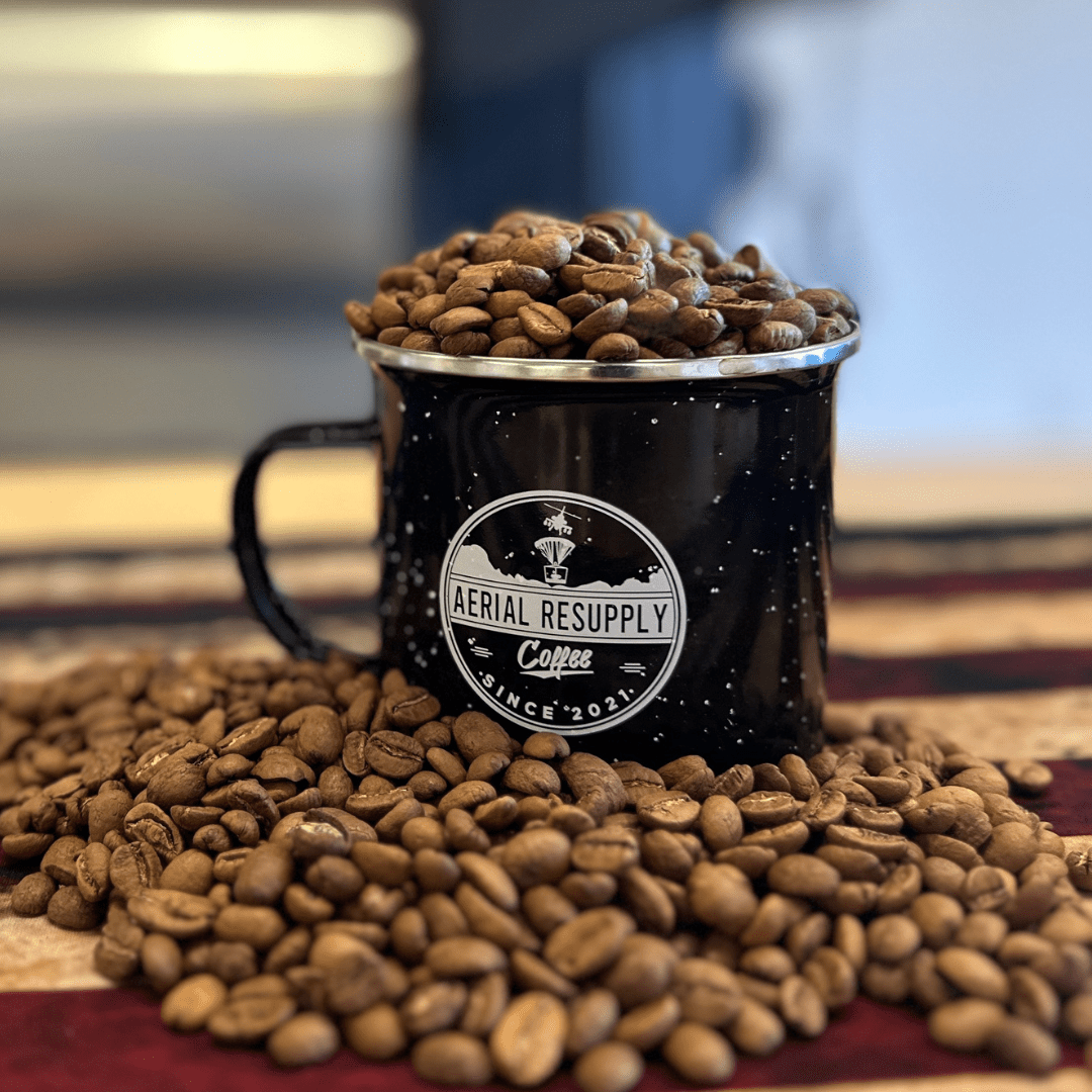 Lifeline Premium Colombian light roast coffee in an Aerial Resupply Coffee Logo campfire mug on an American flag. 