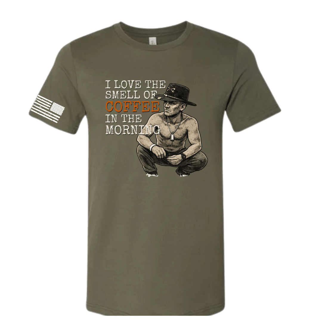 Olive green t-shirt with graphic of a man and text 'I love the smell of coffee in the morning' on a white background