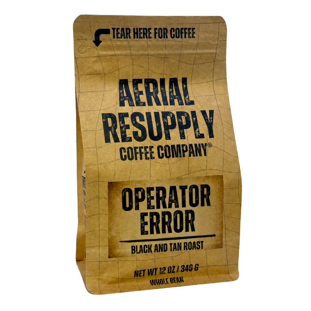 A 12 oz bag of Aerial Resupply Coffee Company Operator Error black and tan roast coffee, shown on a clean white background.