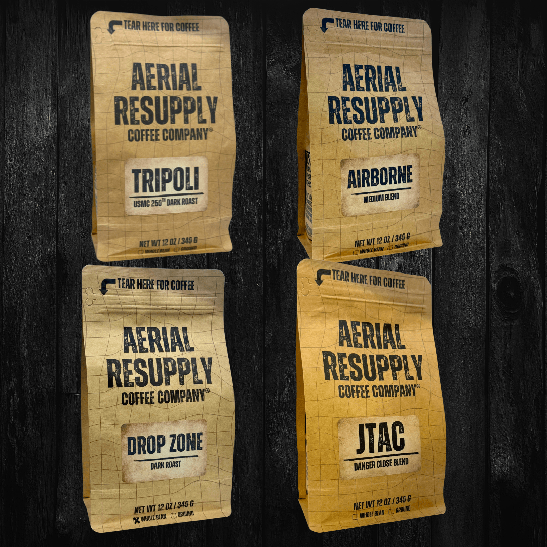 Four packages of Aerial Resupply Coffee Company on a dark wooden background