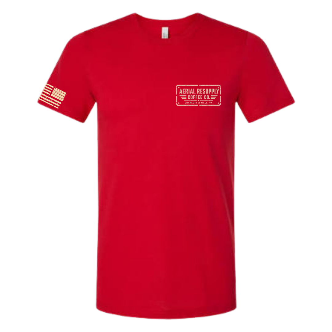 A red short-sleeve crewneck t-shirt with a white rectangular chest logo reading 'AERIAL RESCUE THE COFFEE CO. OF PA' and a white American flag graphic on the right sleeve, shown on a plain white background.
