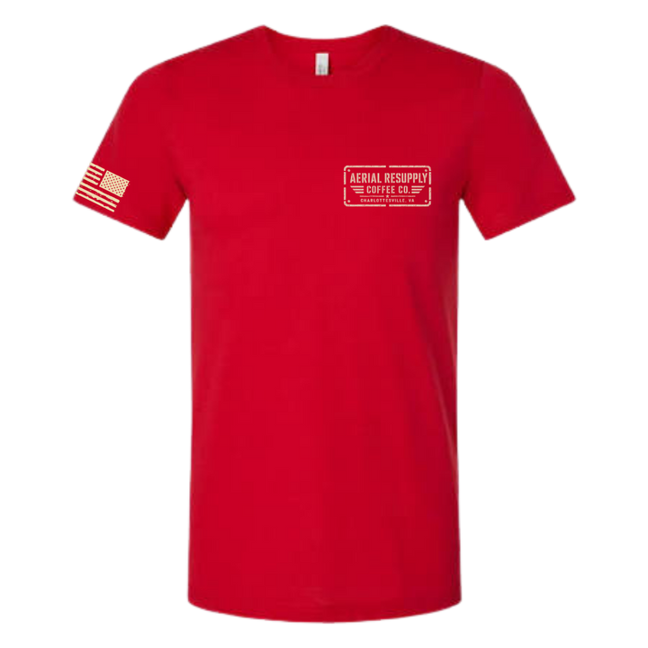 A red short-sleeve crewneck t-shirt with a white rectangular chest logo reading 'AERIAL RESCUE THE COFFEE CO. OF PA' and a white American flag graphic on the right sleeve, shown on a plain white background.