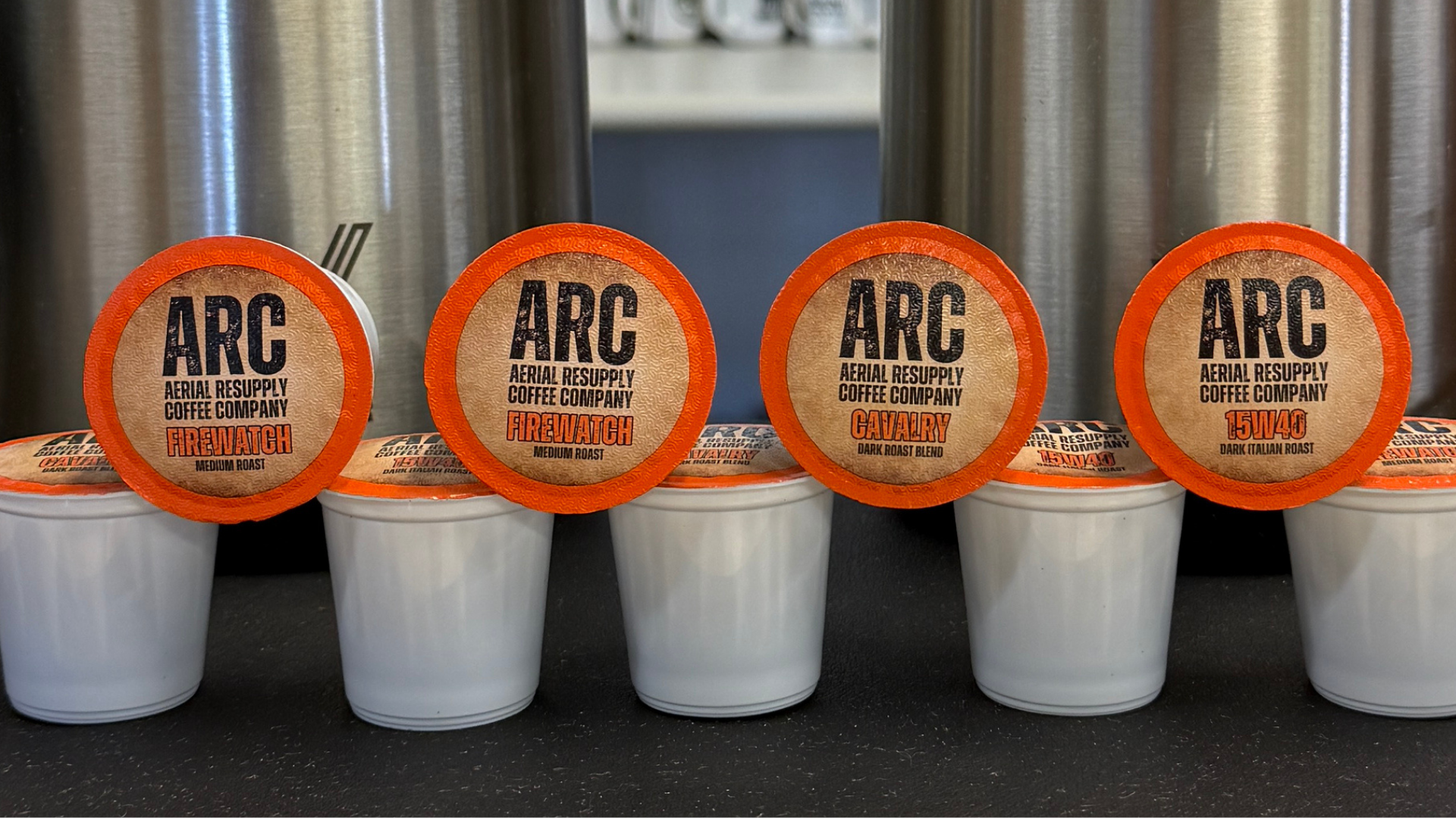 Single Serving pods stacked with Aerial Resupply Coffee logo