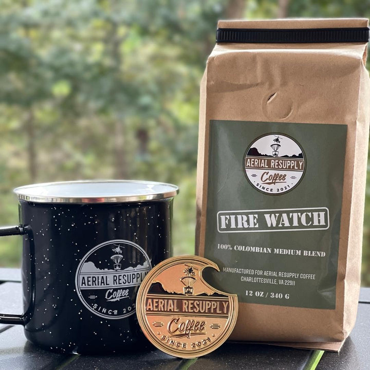 Aerial Resupply Coffee challenge coin with a bag of firewatch medium roast coffee and a campfire logo mug.